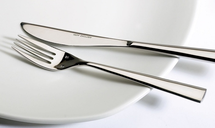 a silver fork and knife on a white plate
