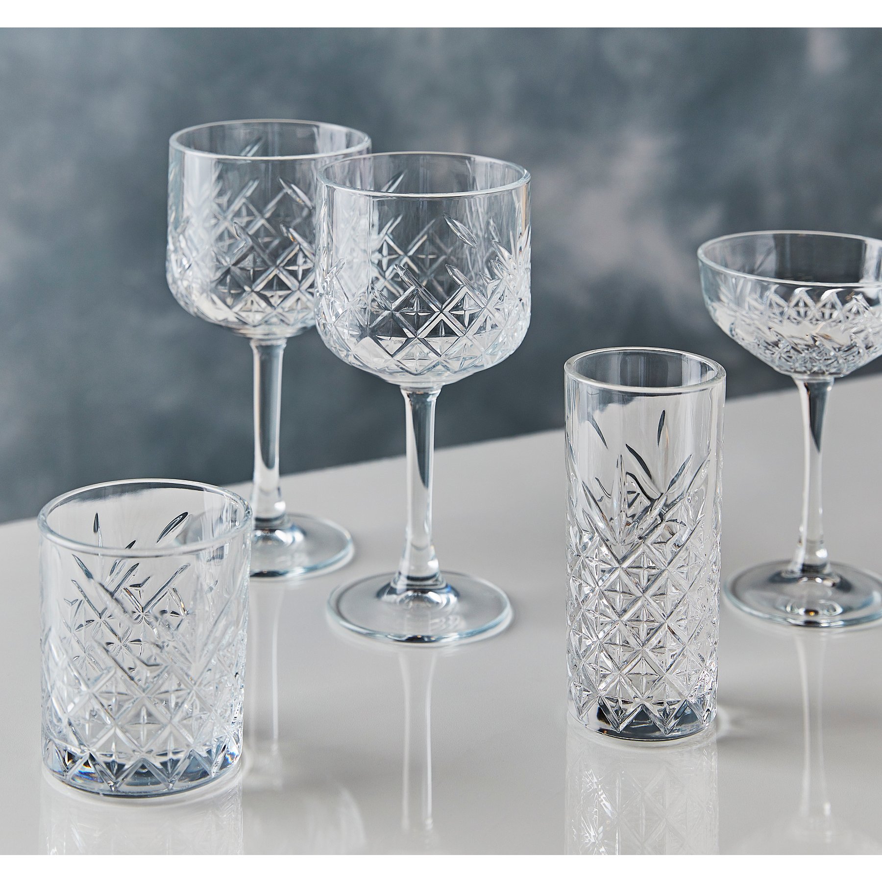 a group of crystal glasses on a table